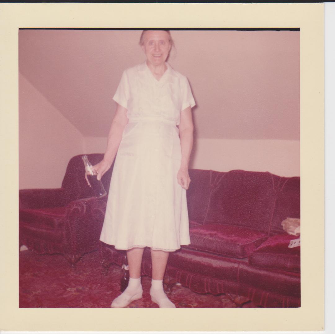 Hazel standing in white dress