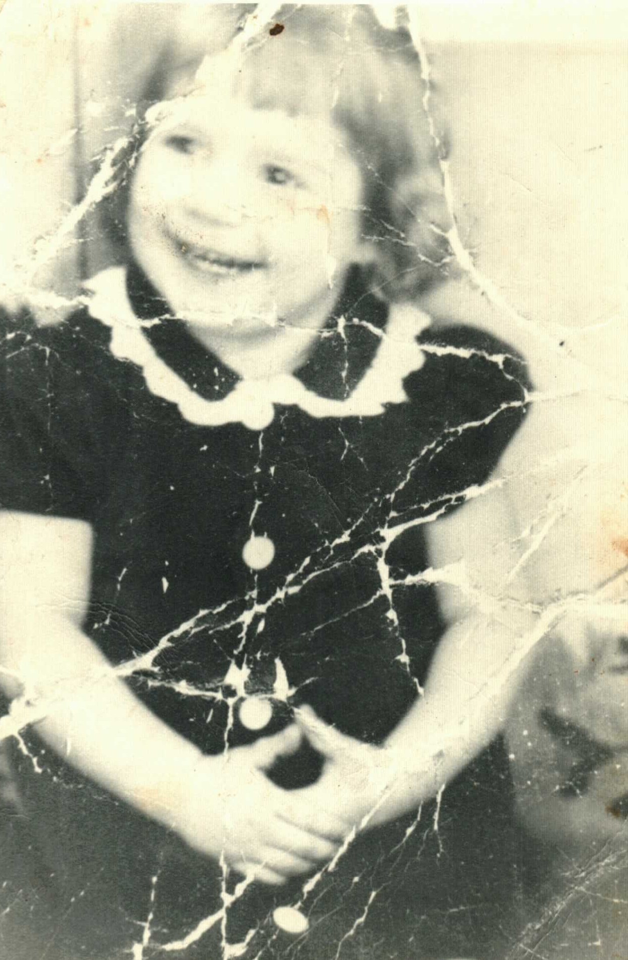 Virginia sitting sweetly in a ruffled dress